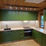 Zabudowa kuchenna na wymiar – zielone fronty i drewniane wykończenie